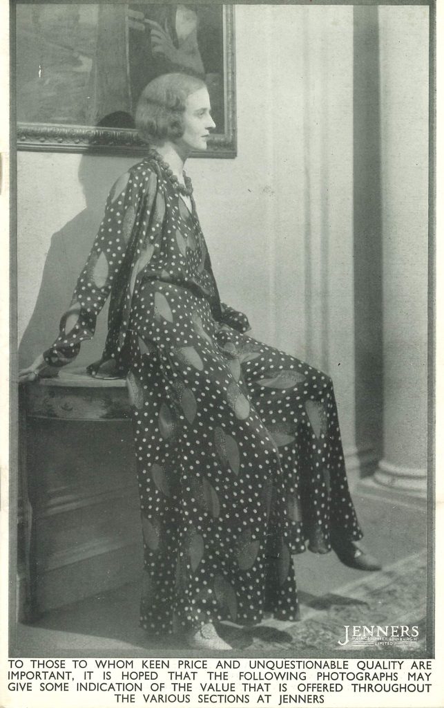 Page de catalogue Jenners de 1931 en noir et blanc, montrant une femme vêtue d'une robe ample à pois assise sur un petit bureau sous un tableau encadré.